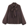 Elettra Ferri polka dot tiered V-neck blouse in casualwear style, featuring a flowy design with layered tiers and a V-neck collar.
