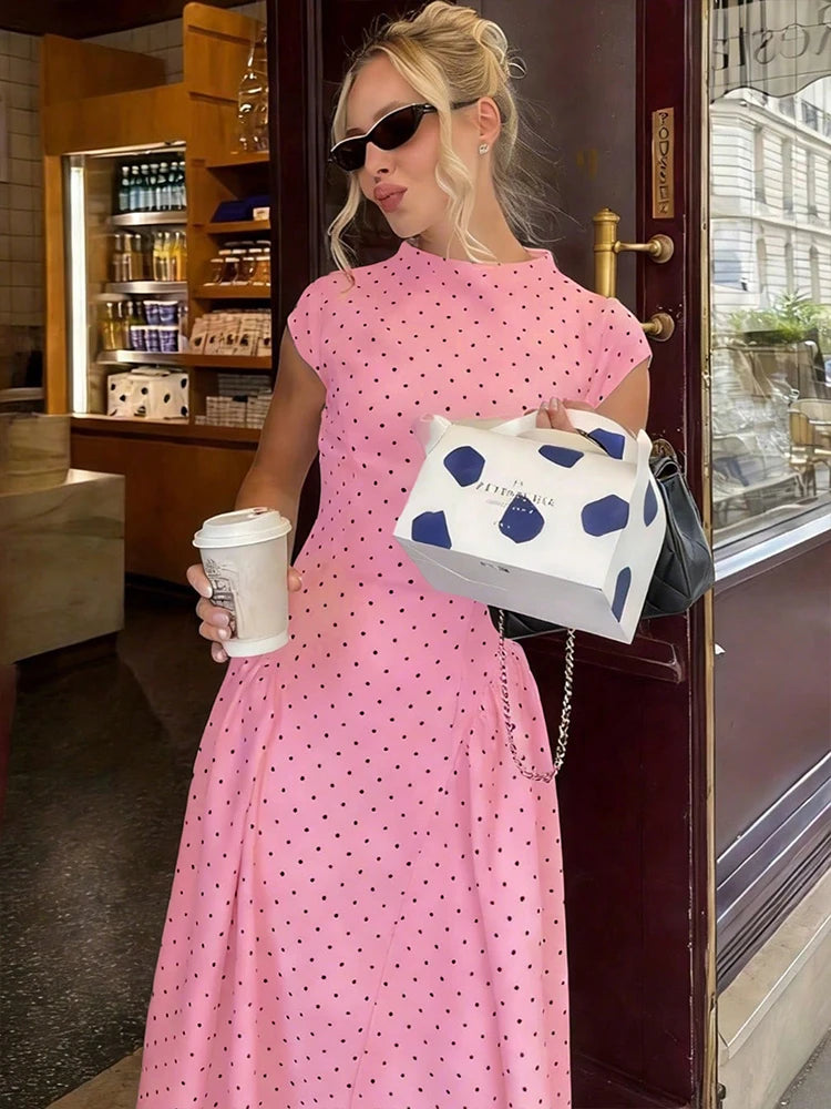 Elettra Ferri polka dot slim maxi dress with a fitted bodice and flowing skirt, featuring classic black and white polka dots.