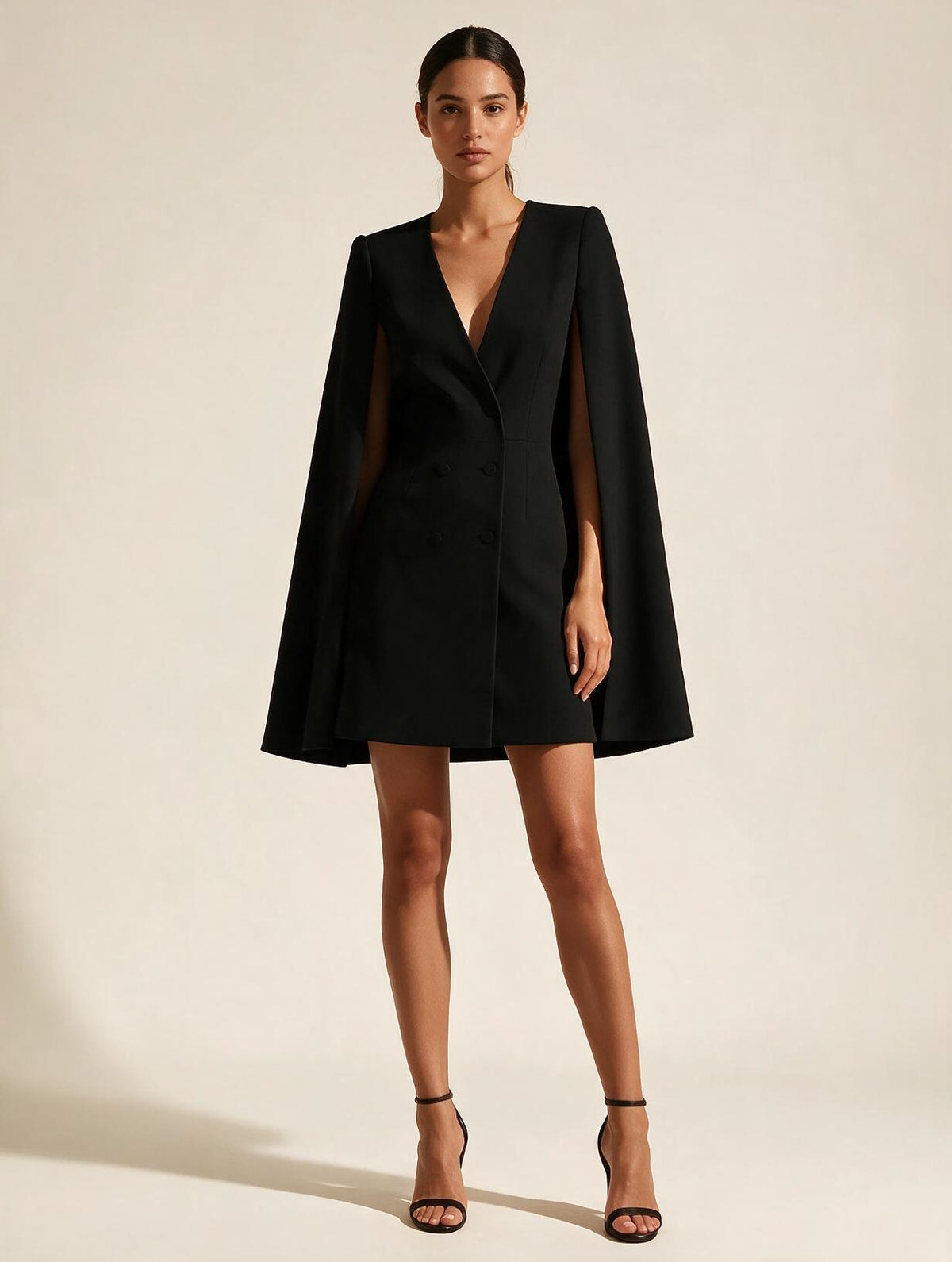 Elettra Ferri V-neck mini dress with cape sleeves modeled on a woman, showcasing elegant evening wear design.