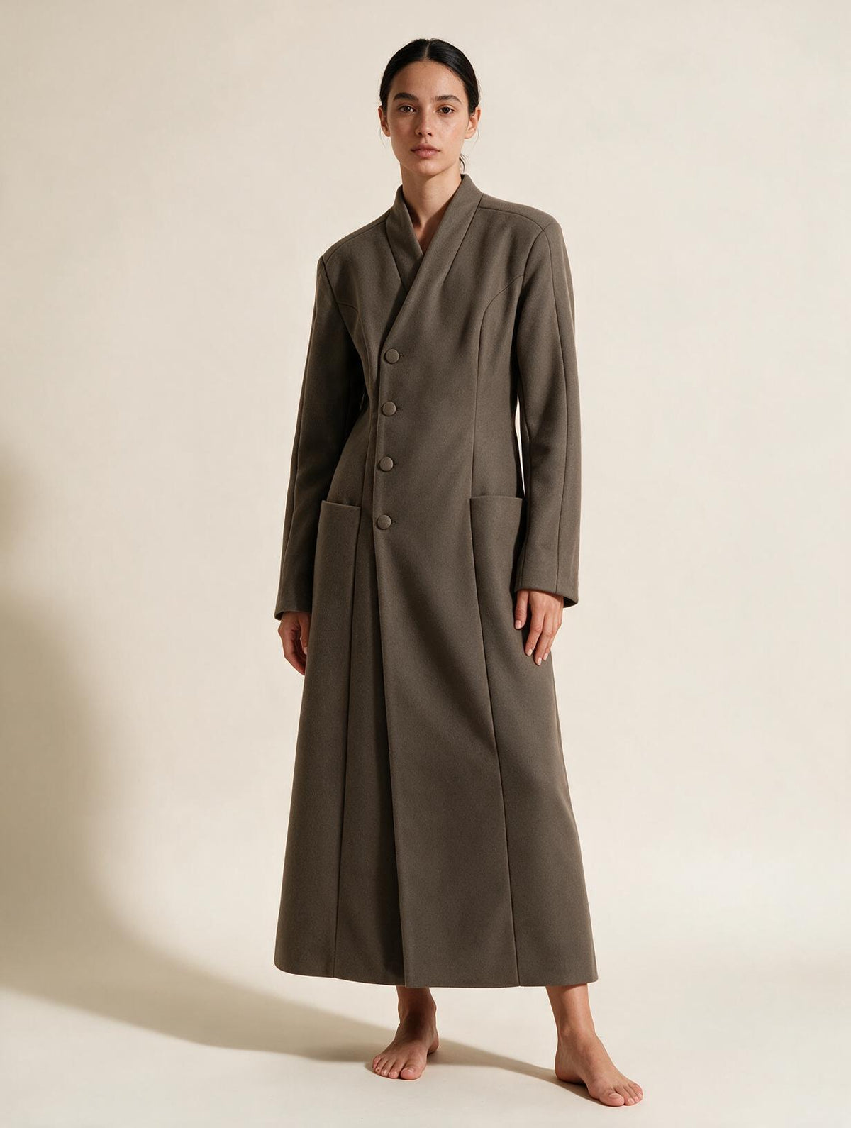 Elettra Ferri long tailored waist-cinched coat worn by a model, featuring a fitted silhouette and classic design.