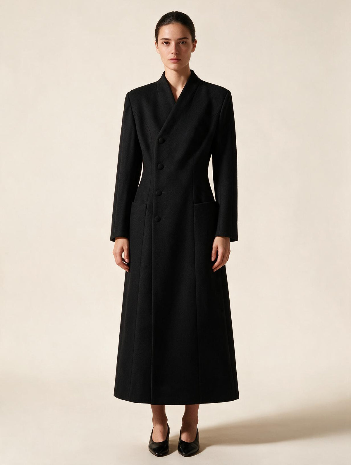 Elettra Ferri long tailored waist-cinched coat worn by a model, showcasing a stylish, fitted design in a sleek, modern silhouette.