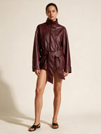 Elettra Ferri solid faux leather coat on a model, showcasing a stylish fashion jacket with a sleek design and collar detail.