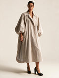 Model wearing Elettra Ferri long oversized puff sleeve trench coat, showcasing its stylish silhouette and oversized design.