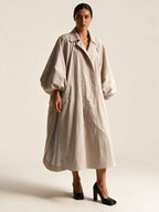 Model wearing Elettra Ferri long oversized puff sleeve trench coat, showcasing its stylish silhouette and oversized design.