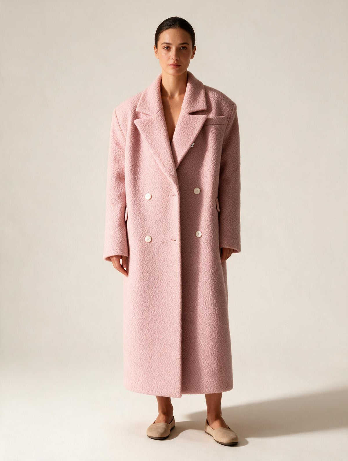 Elettra Ferri long double-breasted wool blend coat on a model, showcasing a classic tailored design in neutral tones.