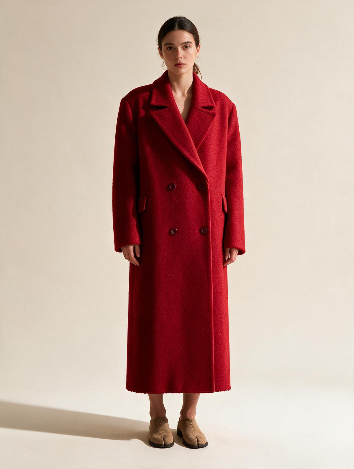 Model wearing Elettra Ferri long double-breasted wool blend coat, showcasing its tailored fit and classic style.