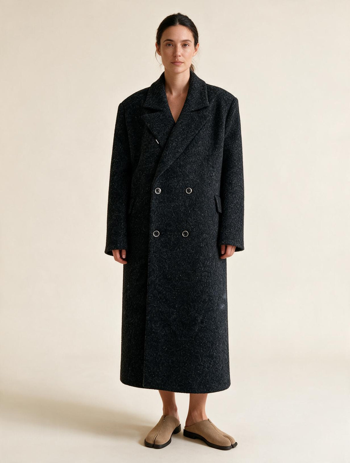 Model wearing Elettra Ferri long double-breasted wool blend coat, showcasing its tailored fit and classic style.