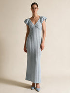 Elettra Ferri V-neck openwork maxi dress modeled on a woman, stylish flowy dress with intricate openwork details.