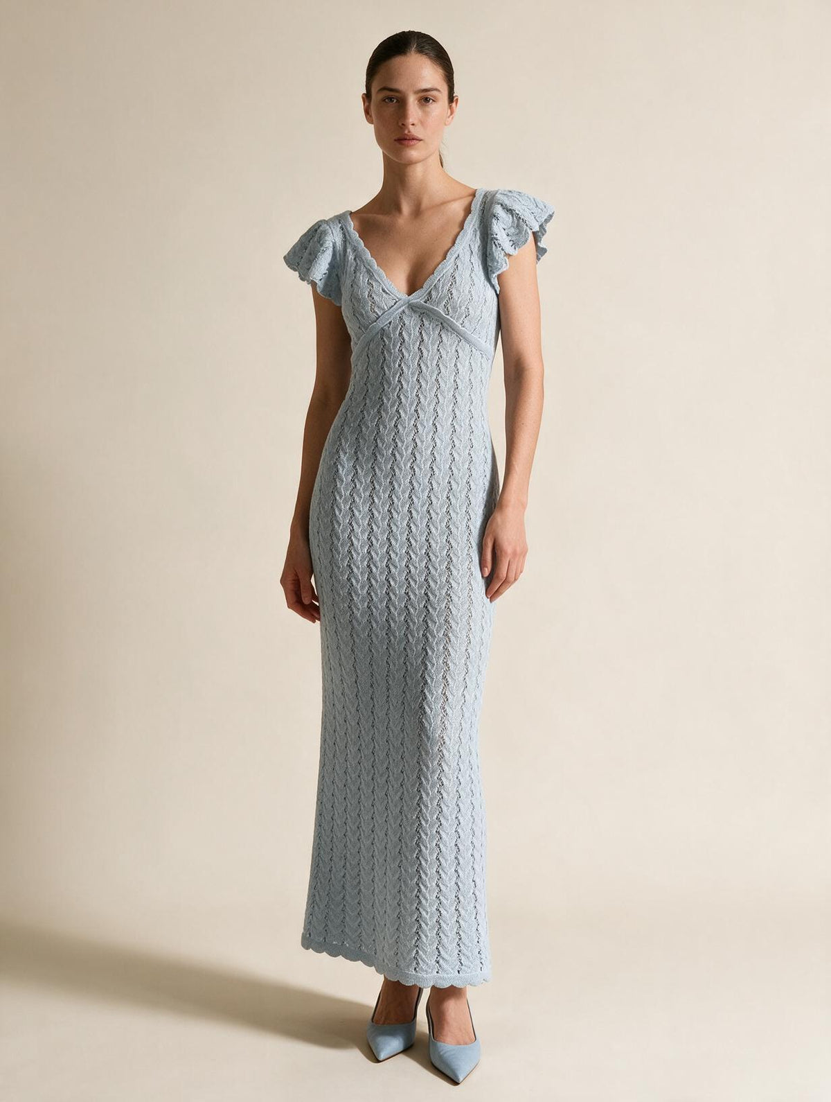 Elettra Ferri V-neck openwork maxi dress modeled on a woman, stylish flowy dress with intricate openwork details.