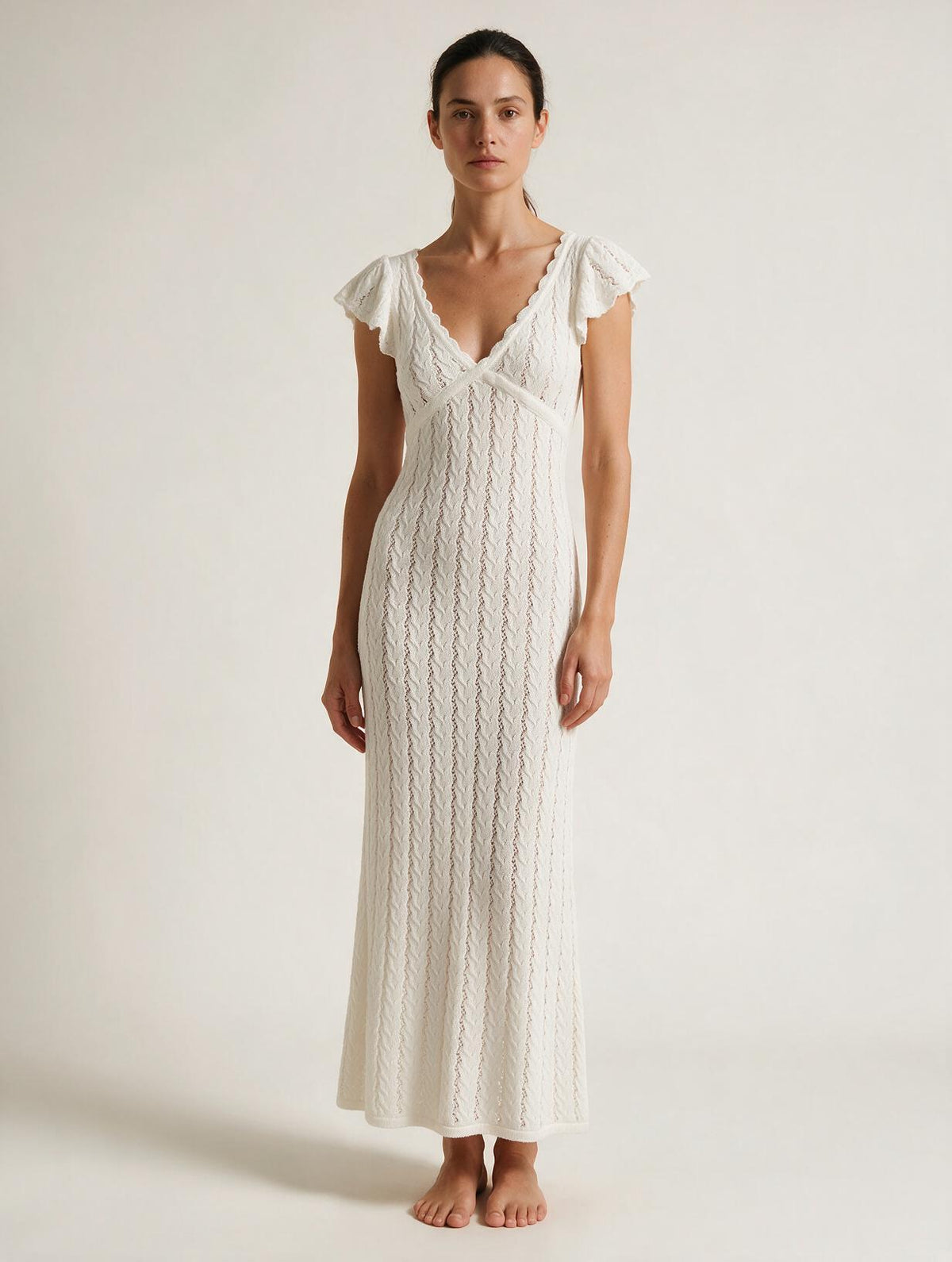 Elettra Ferri V-neck openwork maxi dress on a model, featuring a flowing design with intricate openwork fabric.
