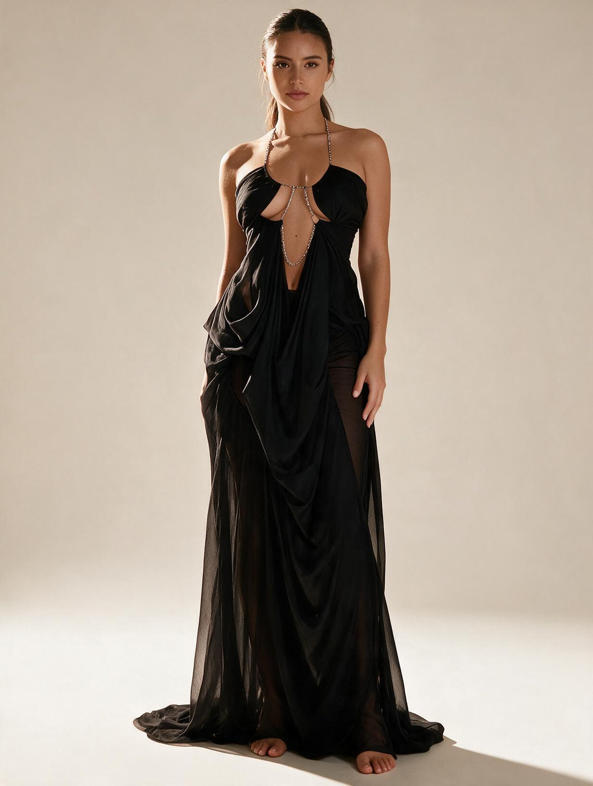 Elettra Ferri halter neck maxi dress with mesh details on a model, showcasing elegant evening wear.