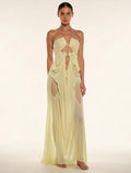 Elettra Ferri halter neck maxi dress with mesh details on a model, featuring a flowing silhouette and elegant design.