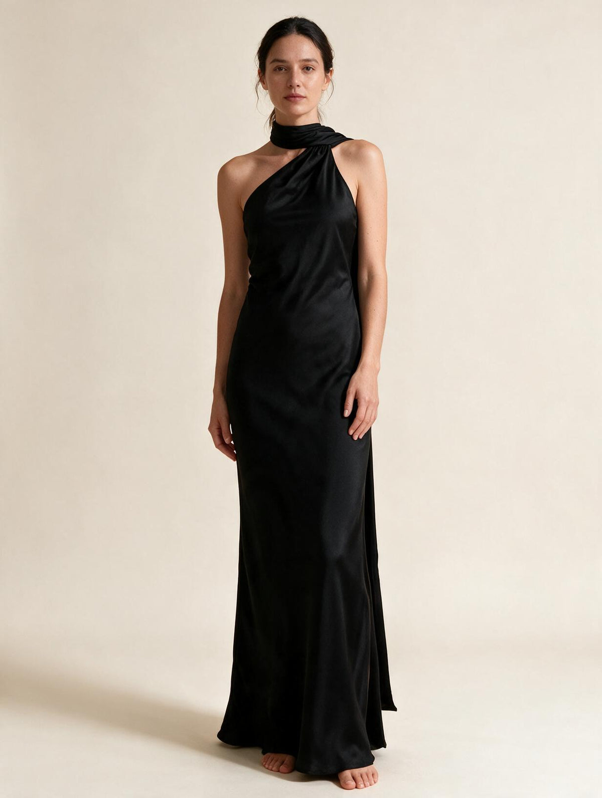 Elettra Ferri halter maxi dress modeled on a woman, flowing fabric with a fitted bodice and full-length skirt, elegant evening wear.