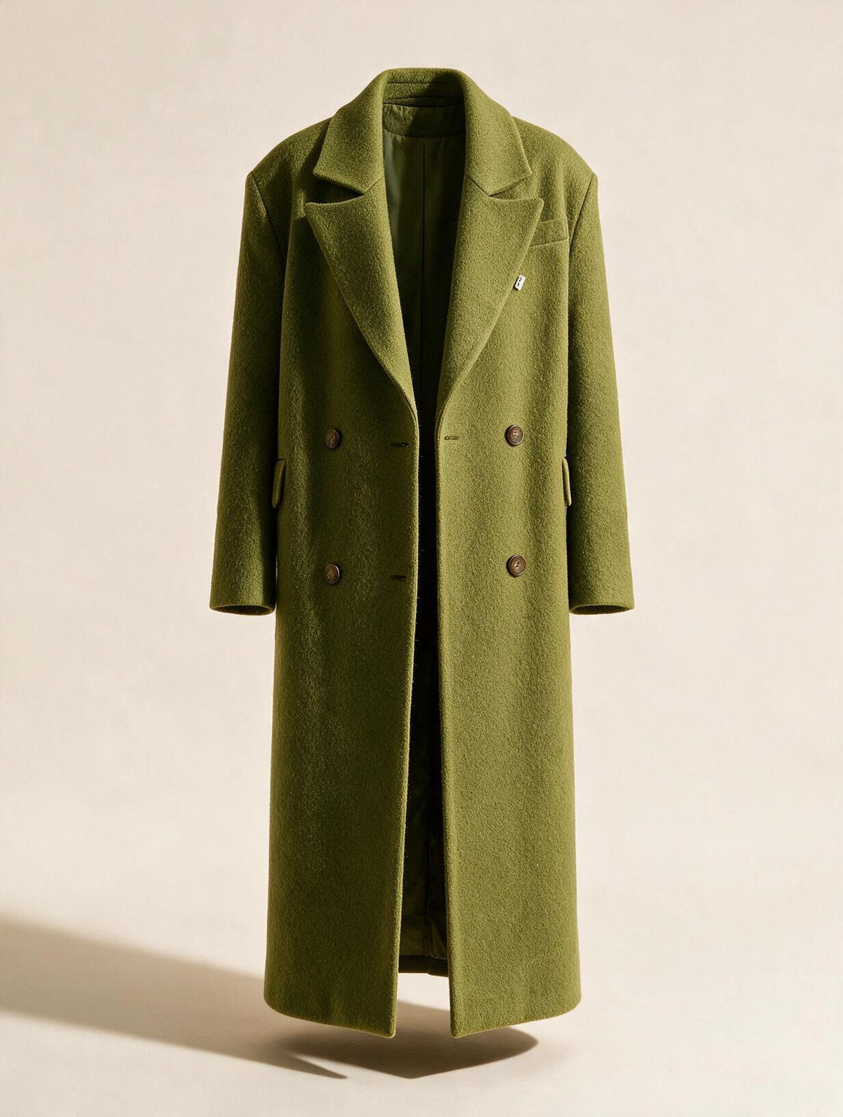 Elettra Ferri long double-breasted wool blend coat hanging on a rack, showcasing its tailored lapels and classic design.