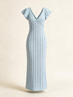 Elettra Ferri V-neck openwork maxi dress in flowing fabric with intricate cutout details, displayed on a hanger.