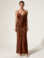 Elettra Ferri V-Neck Maxi Dress displayed on a hanger, featuring flowing fabric and a stylish V-neck design.
