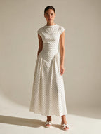 Elettra Ferri polka dot slim maxi dress with a fitted silhouette and flowing fabric, featuring a classic black and white dot pattern.